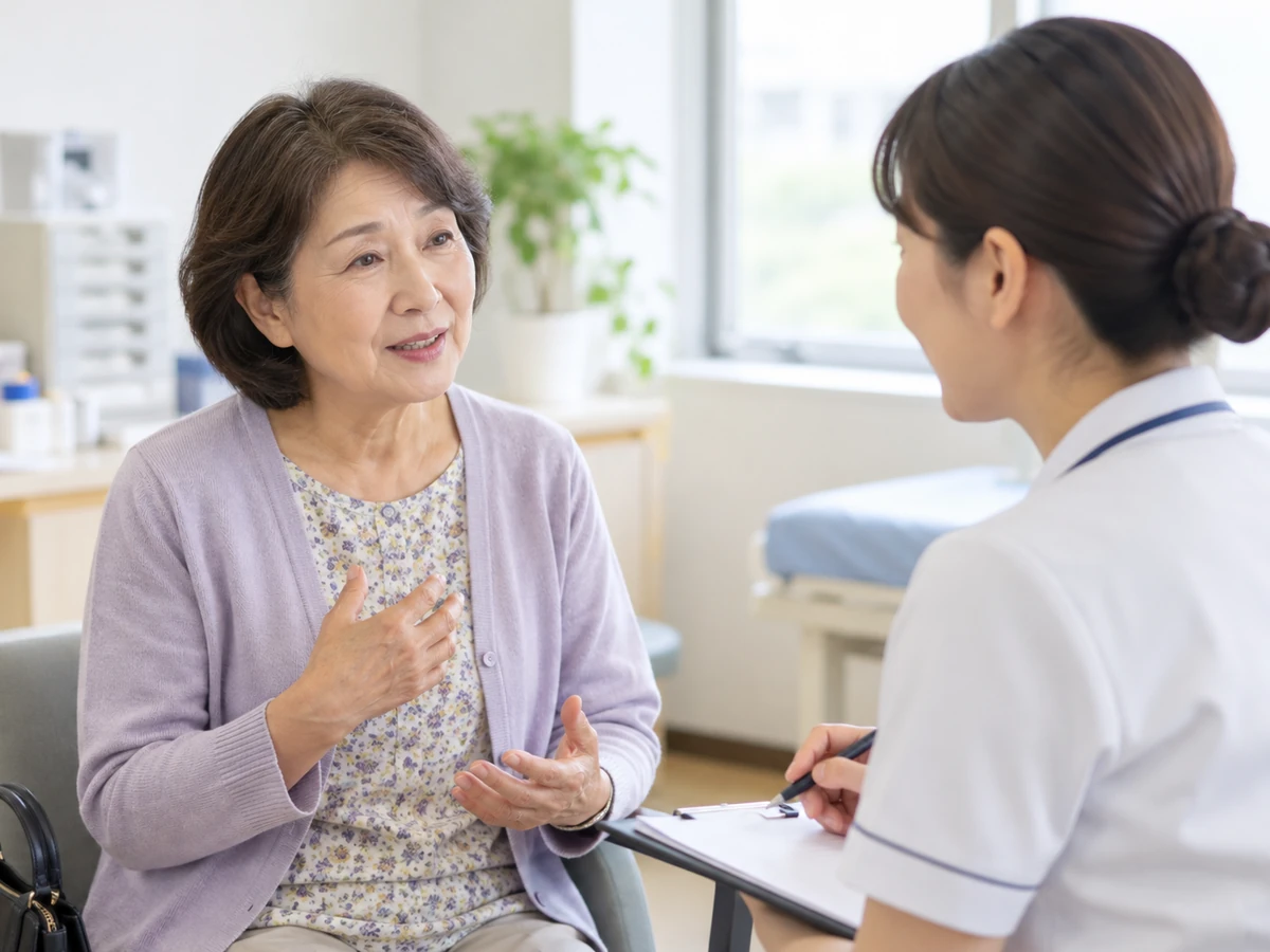 看護師に最近の体調の変化を伝える女性のイメージ。