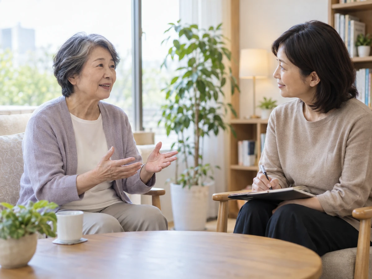 明るい相談室で高齢の女性が相談員に気持ちを話しているイメージ