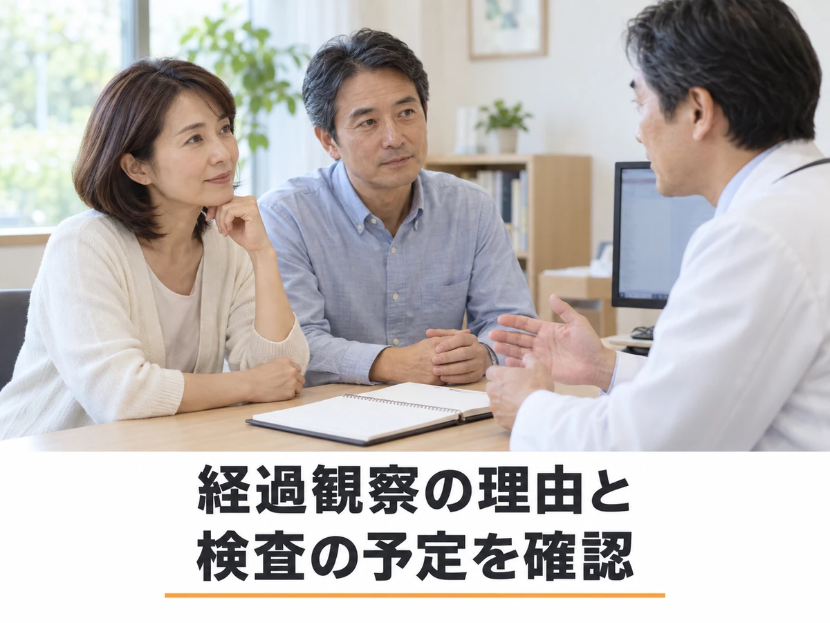 経過観察の理由と検査の予定を主治医に確認する夫婦